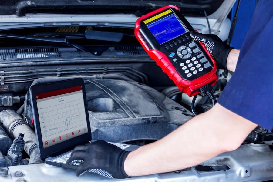 mechanic running diagnostics on car